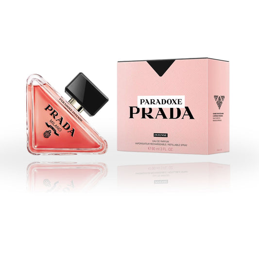 a sleek, triangular glass bottle with a deep coral hue, adorned with the signature Prada logo and a black cap, exuding elegance and modernity.